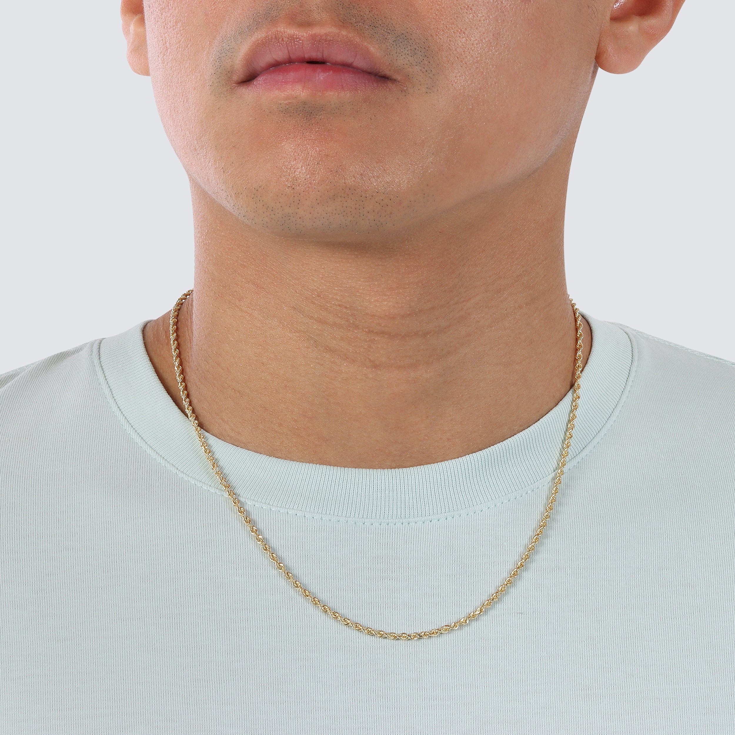 a photo of 2.5mm rope chain diamond cut in 14k, 18k and 22k solid gold on a model's neck.