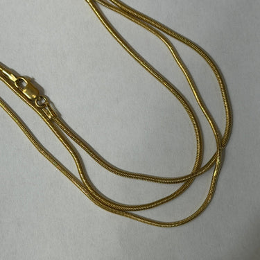 18k gold snake chain 1mm made in italy solid on light gray background