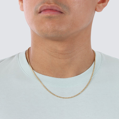 A photo of 2mm rope chain in 14k and 18k solid gold on a model's neck.