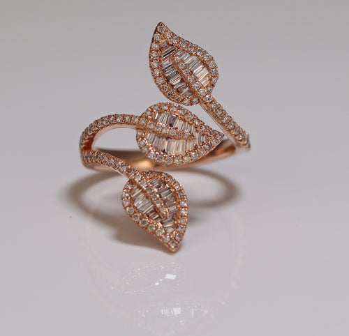 A three-leaf shaped diamond ring featuring baguette and princess cut diamonds.