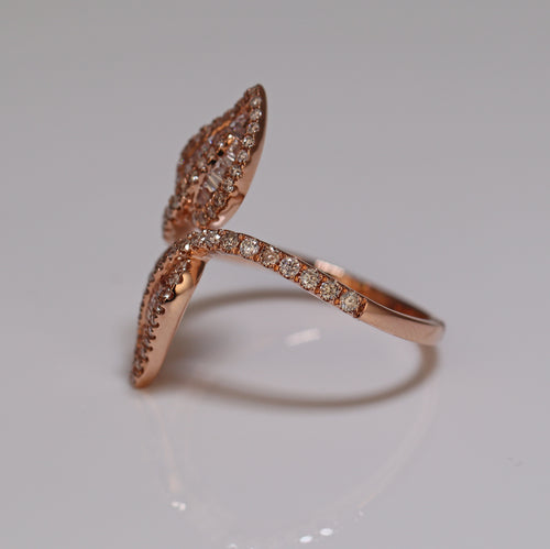 a photo of ring with two leaves shaped diamond setting princess cut and baguette side photo