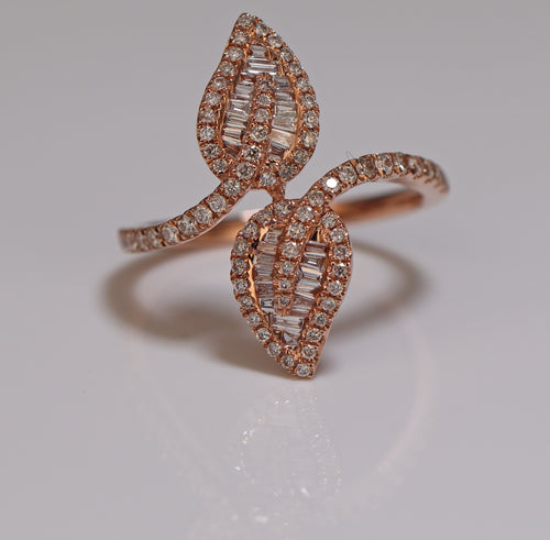 a photo of ring with two leaves shaped diamond setting princess cut and baguette 