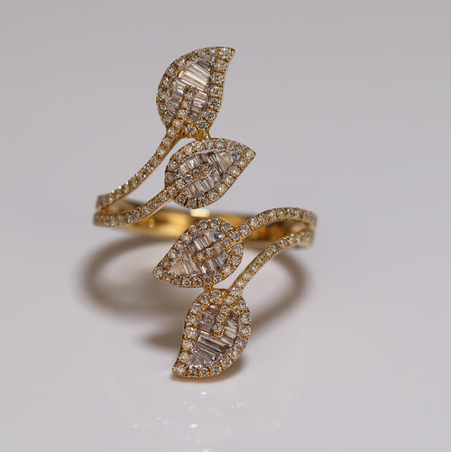 a photo of a ring with a four leaves style and with baguette and princess cut studded diamonds iced out