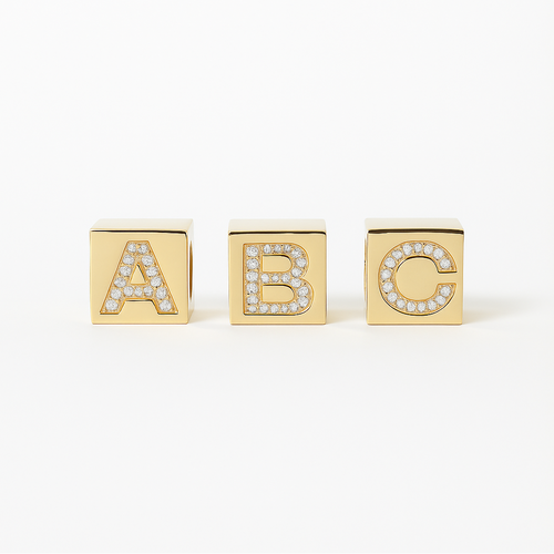 Three gold blocks with diamond custom made 'A', 'B', and 'C' on a white background