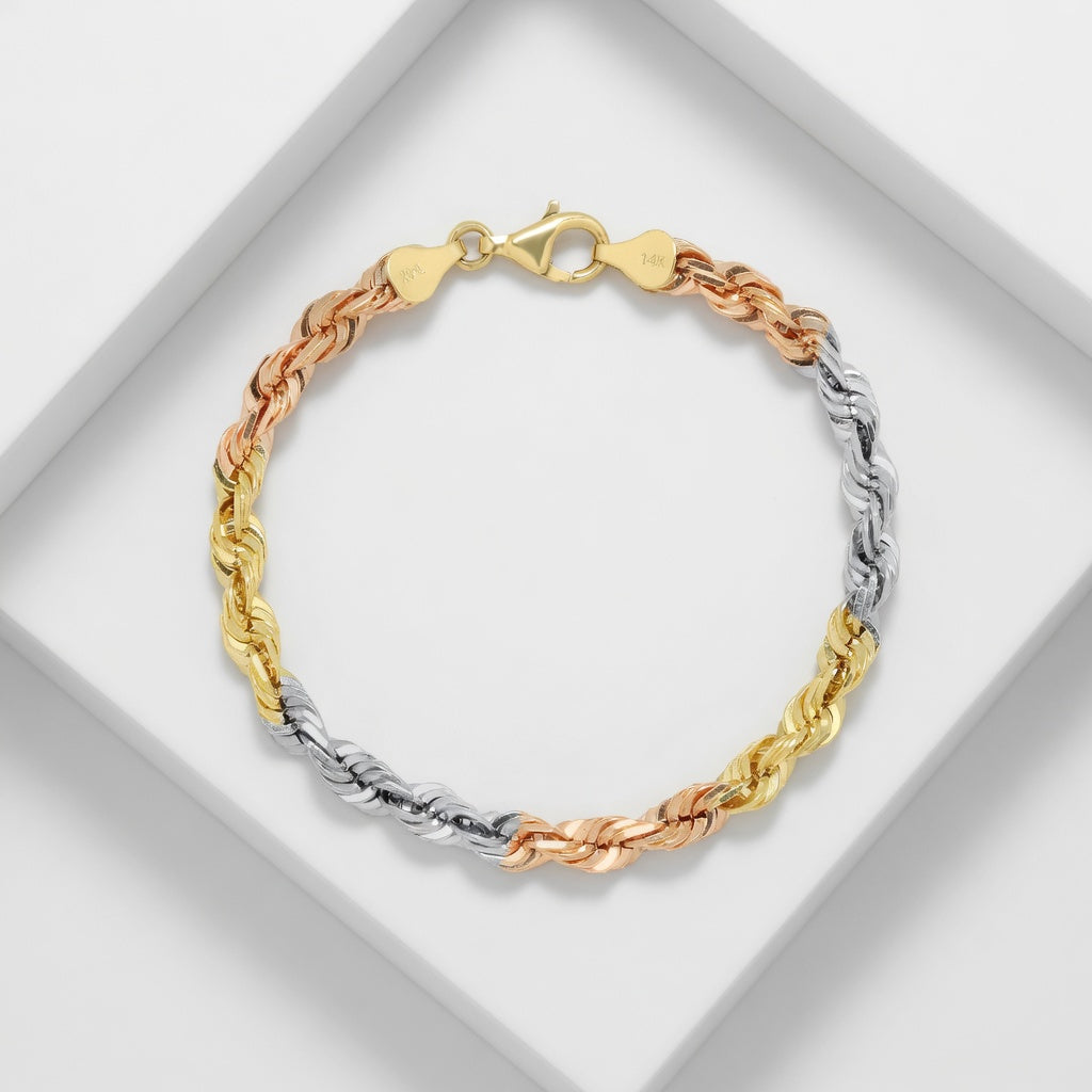 Three-tone gold, rose gold, and silver bracelet on a white background