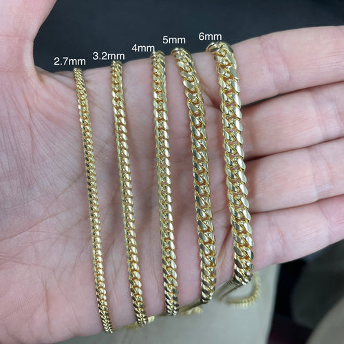 A photo of 2.7mm Miami Cuban Chain in Yellow 14k and 18k Solid Gold made in Italy stamped Italy and stamped according to purity in all gauges with a detailed product shot 